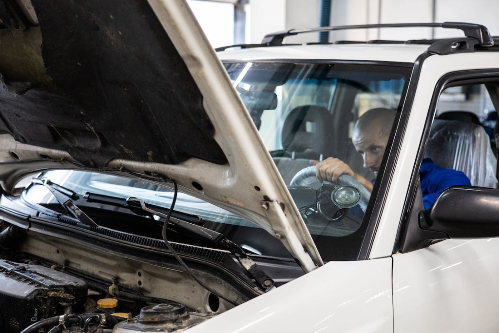 Professional conducting a thorough car inspection.