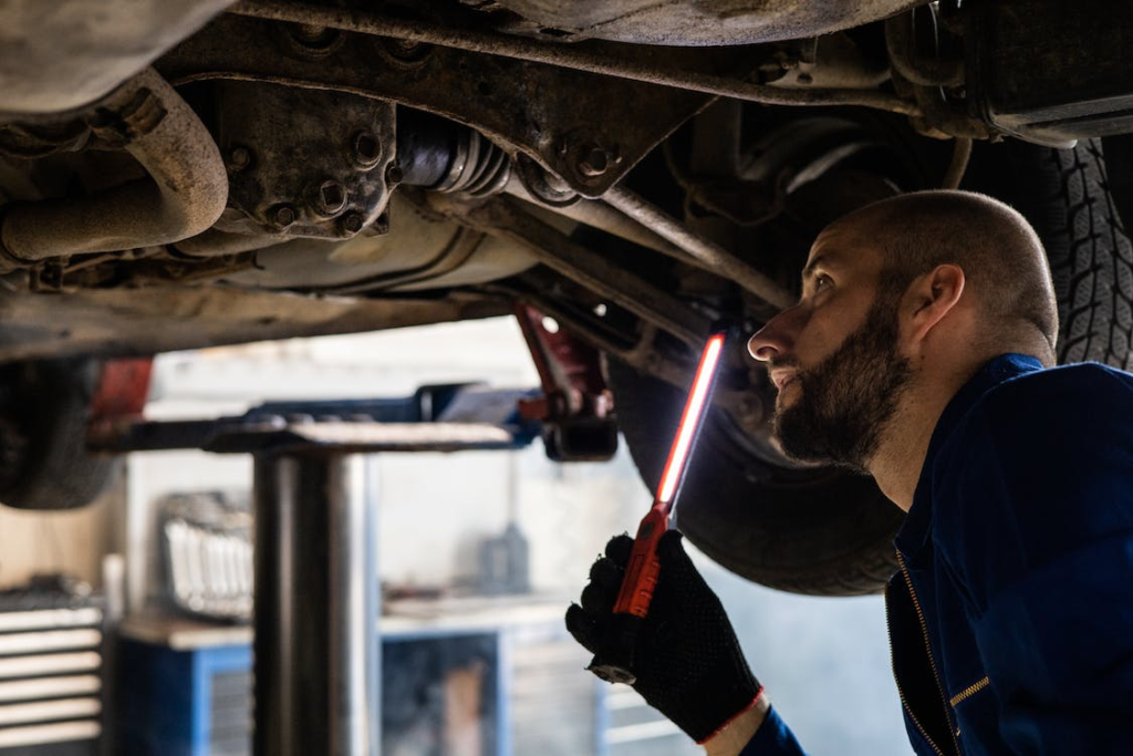 Man evaluating the condition of a car for a market value report.