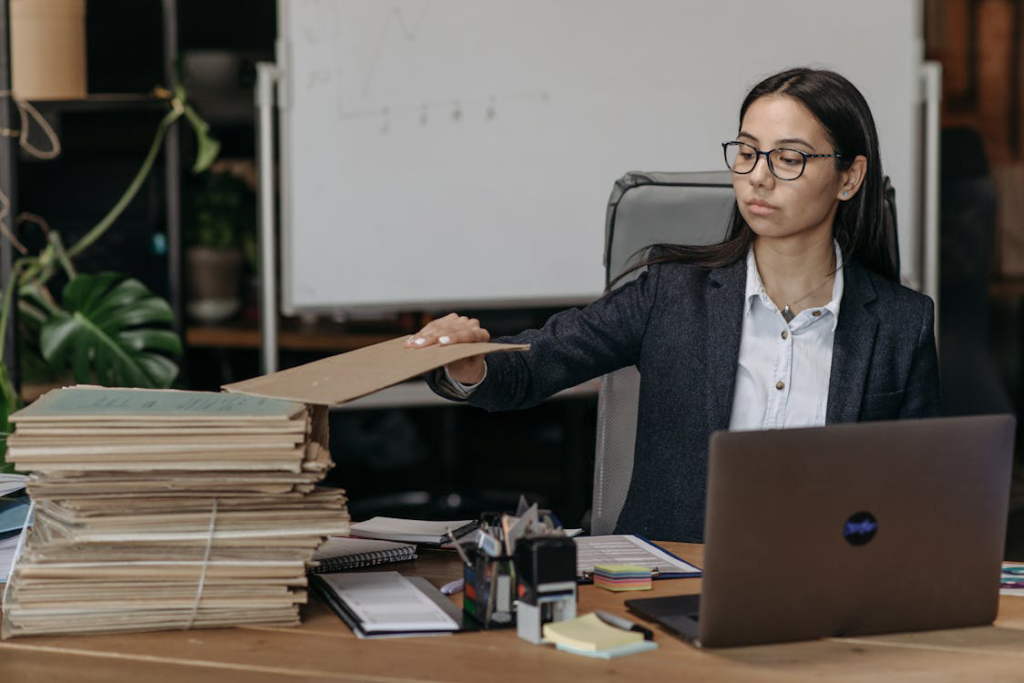 a person reviewing a stack of files