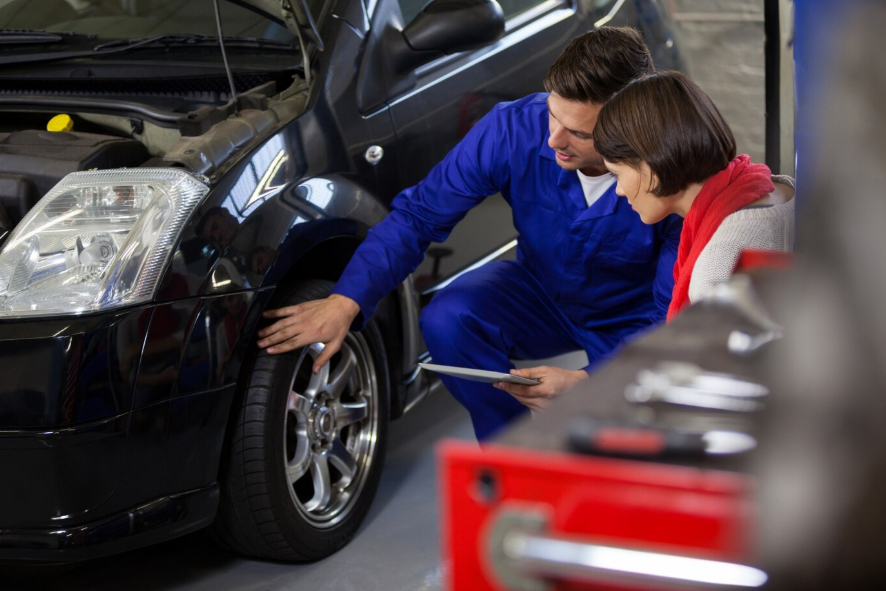 a mechanic talking to a customer