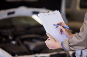 a female mechanic preparing a checklist