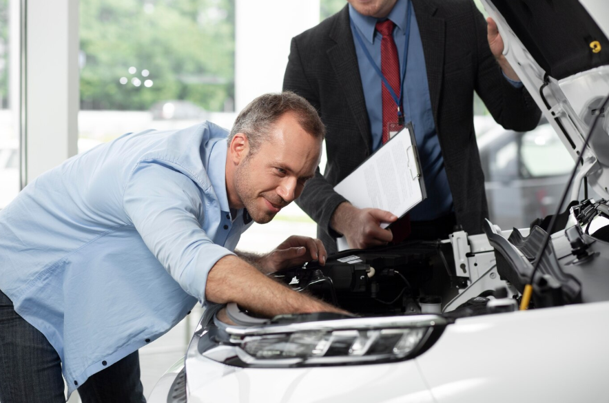 men inspecting a car