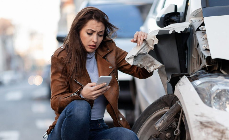 a woman using the phone after an accident